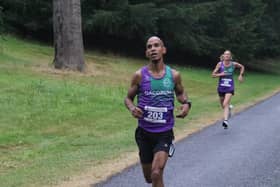 Dacorum AC's David Olima leads team-mate Kate Rennie to the finish line. Photo by Barry Cornelius.