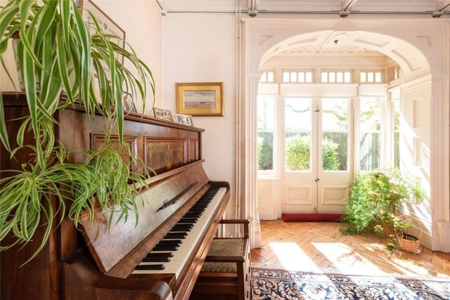 The entrance hall to Tythe House includes a piano