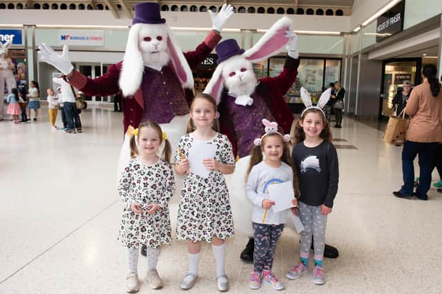 Friars Square Shopping Centre Easter Event - Children meet jolly white rabbits Daffy and Dew, photo by Derek Pelling