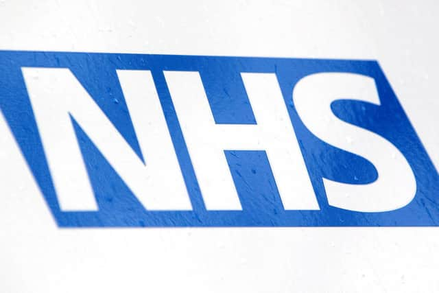 NHS logo, photo from Yui Mok/ PA Wire/PA Images