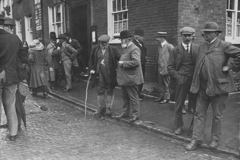 A group of farmers discuss the insurance protest meeting they have just attended in Aylesbury on 10th August 1912.