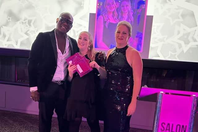 Safy Burton collecting one of her three awards