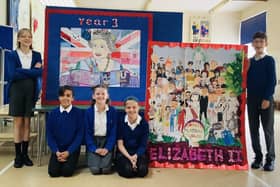 Children pose with their work