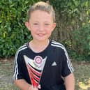 Smiling Alfred with his football trophy