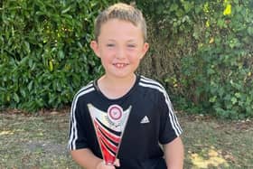 Smiling Alfred with his football trophy