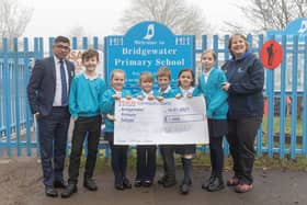 Yassas Jayasinghe Tesco Northchurch Express Store Manager presents the cheque to pupils at Bridgewater School and their Headteacher Andrea Bettridge
