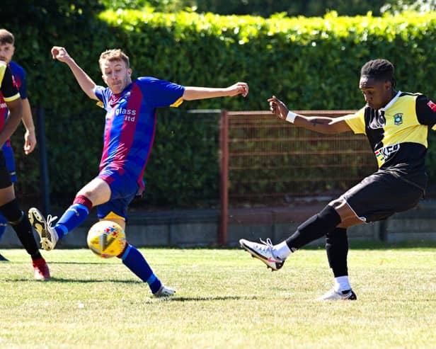 Aylesbury's Evans Lamboh with an early strike at goal during Saturday's tie. Photo by Mike Snell.