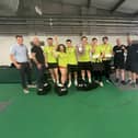 The winning team showing off the trophy