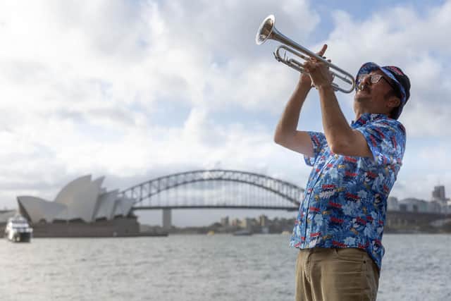 Simon Finch, the Barmy Army trumpeter, marking one-year until the Ashes in Austrsalia t Sydney Harbour