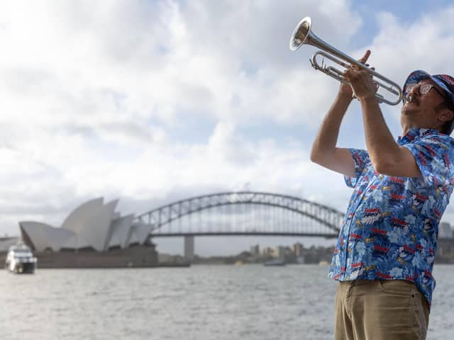 Simon Finch, the Barmy Army trumpeter, marking one-year until the Ashes in Austrsalia t Sydney Harbour