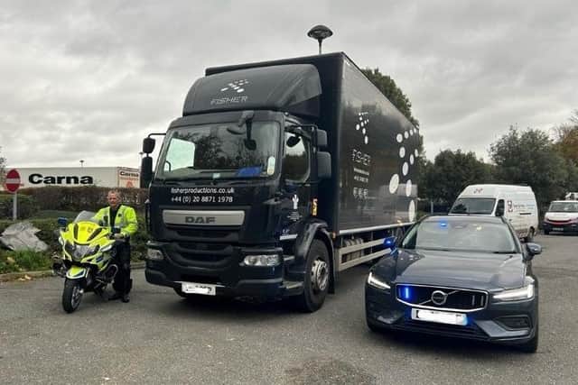 A Roads Policing officer and the lorry used in Op Orbital