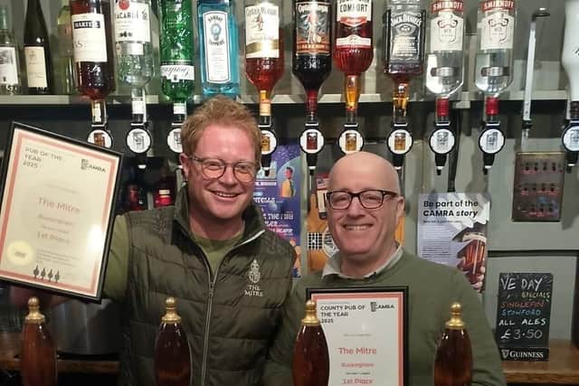 Pete Edwards (left) proudly receives the awards from David Martin of CAMRA
