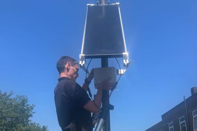 One of the air quality sensors being installed