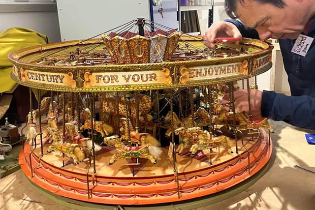 Repairing the model merry-go-round for Thame Museum