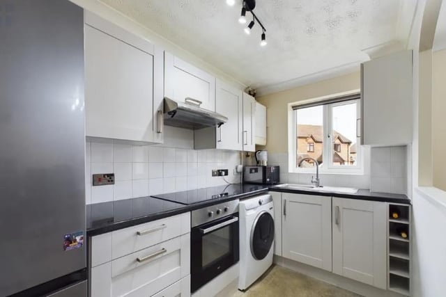The home's kitchen which contains a host of useful appliances including a washing machine.