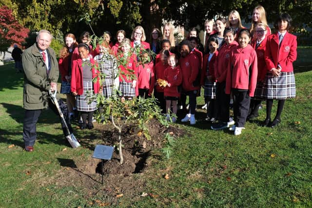 Vice Lord-Lieutenant Alexander Boswell with Prep and Senior Eco Committee students planting the tree