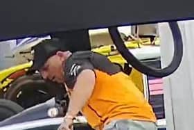 Police have released an image of a man they wish to speak to after a steering wheel was stolen from a display car at Silverstone last weekend.