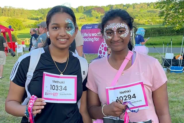 Race for Life supporters proudly show their medals for completing the 5k course