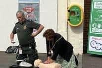 Anja Schaeffer Mayor does CPR as Richard Watkins Community First Responder demos using an AED