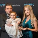 Meral Hasanov, Helin Hasanova, and their daughter Eliza Hasanova, collecting the award
