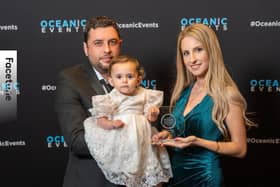 Meral Hasanov, Helin Hasanova, and their daughter Eliza Hasanova, collecting the award