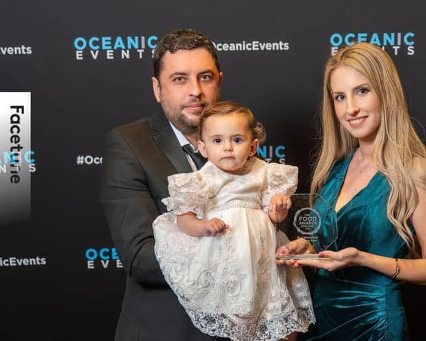 Meral Hasanov, Helin Hasanova, and their daughter Eliza Hasanova, collecting the award