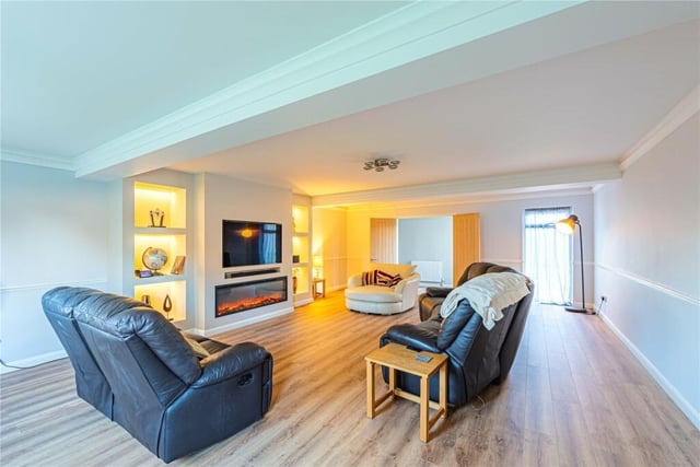 The living room is over 26 feet in length and has a remote-controlled feature fire and atmospheric mood lighting. There’s plenty of space for a cozy night in watching movies.