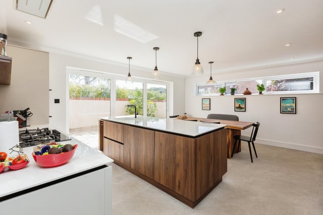 The open-plan kitchen diner with bi-fold doors to the patio courtyard area