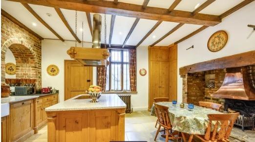 The cosy kitchen has all the appliances you'd expect, along with a dining island and additional table.