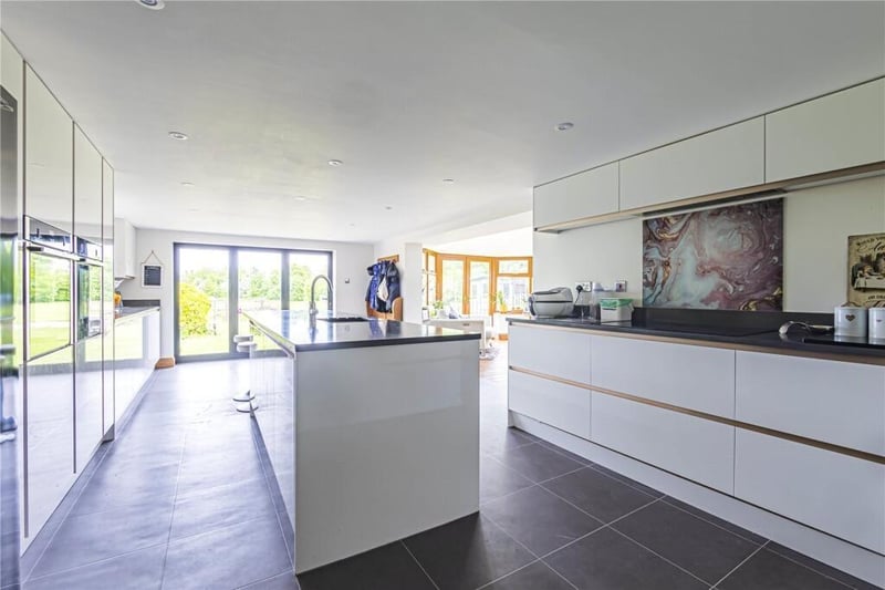 The refitted kitchen is fully integrated  with an impressive island, instant boiling water tap and hide and slide ovens. Imagine cooking up a storm here!