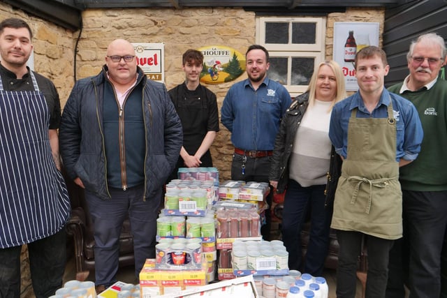 Richard Gordon and the Greedy Gordons team handover donations to Ken Ansdell from Kettering Foodbank.