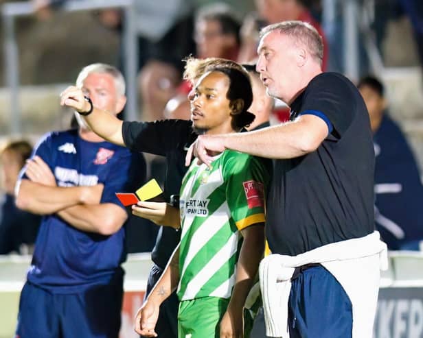 Dave Tuttle (right) gives out instructions on the touchline. Photo: Mike Snell.