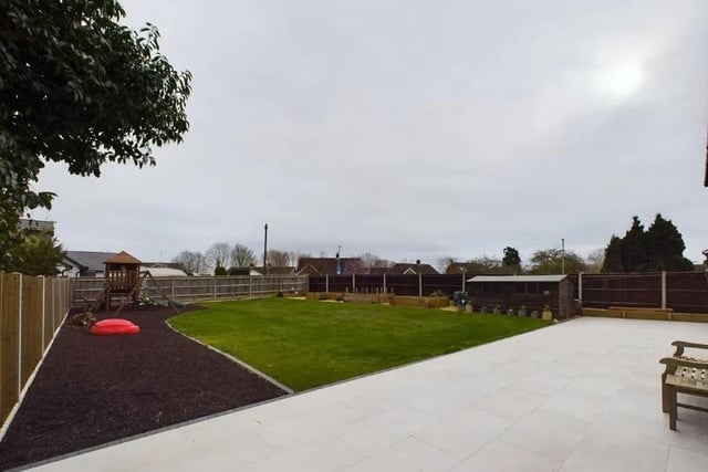 The home has a landscaped rear garden with a paved patio leading to an expanse of lawn laid, gravelled area with built in planters, play area with children's rubber play bark. There is a large garden shed and gated access to the front.