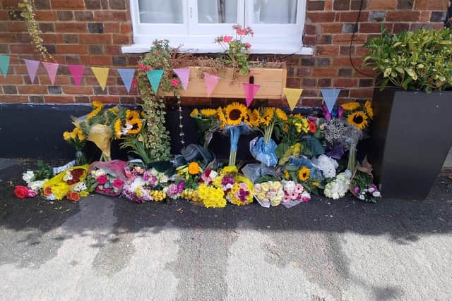 Floral tributes have been left outside The White Swan pub in Whitchurch following the death of its manager Becca Bullock