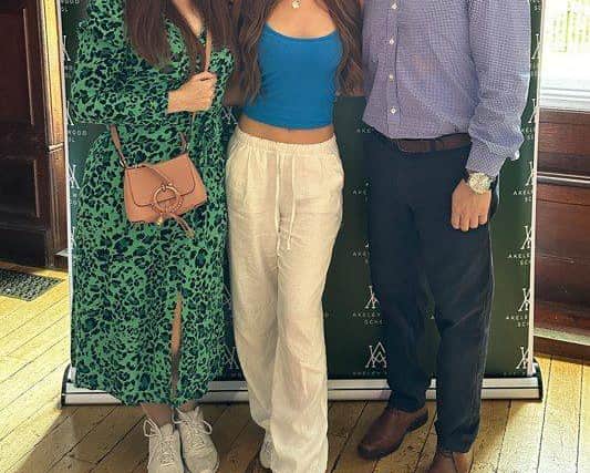Izzy with her parents on results day.