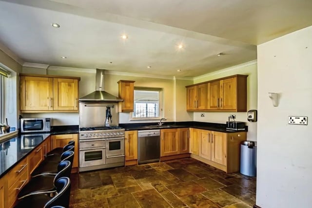 The large open plan kitchen has high end integrated appliances.