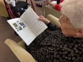 Resident reading Shoebox Stories