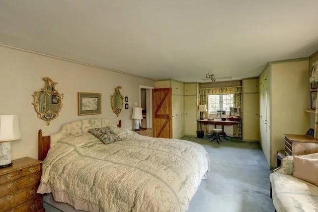 One of six bedrooms in the home. This one includes room to study and a sofa to relax on.