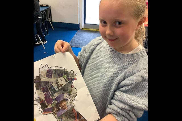 A pupil shows off her artwork