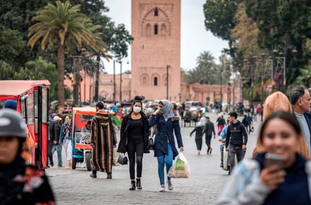 Masked women walk throguh Marrakesh's Jamaa el-Fna square (Getty Images)