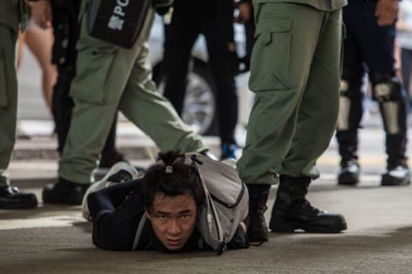 Riot police detain a man as they clear protesters (Photo: DALE DE LA REY/AFP via Getty Images)