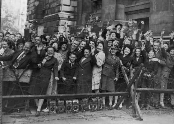 Crowds at Downing Street, London, cheer prime minister Clement Attlee after the surrender of Japan (Photo: Keystone/Getty Images)