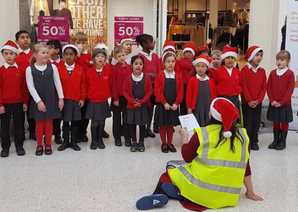 Pupils from Turnfurlong Infant School perform carols at Friars Square in aid of Child Bereavement UK