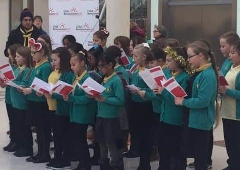Pupils from Ashmead School perform carols at Friars Square in aid of Child Bereavement UK