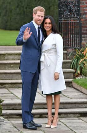 Review of the Year 2017: November: Prince Harry and Meghan Markle, pose during a photocall in the Sunken Garden at Kensington Palace, London, after the announcement of their engagement. PRESS ASSOCIATION Photo. See PA story XMAS Year. Photo credit should read: Dominic Lipinski/PA Wire YPN-171217-115852080