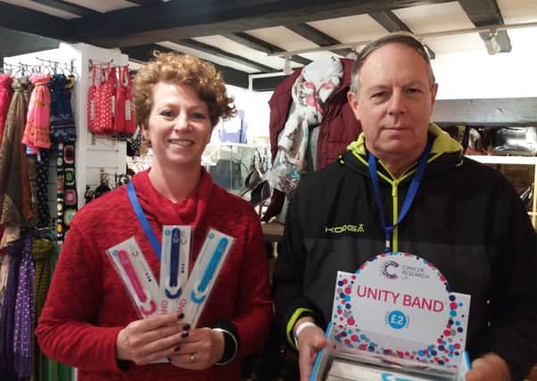 Store volunteers Marion Evans and Robert Truman with Unity Bands.