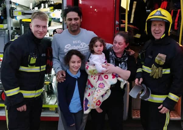 The girl and her family with firefighters following the ordeal