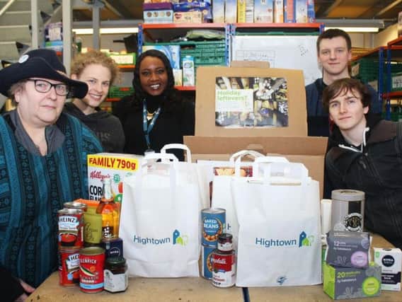 On the left is Heather Joy-Garrett (Manager at Aylesbury Foodbank), third from left is Maureen Bello (Hightown Financial Inclusion Officer), and various volunteers at the foodbank.