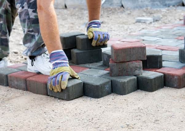 Library image of a brick paver working on a driveway