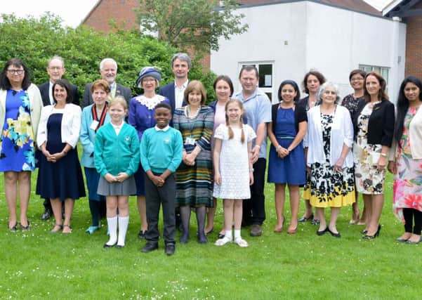 The High Sheriff (centre) is joined by new citizens, chairman Netta Glover, cabinet member Noel Brown, headteacher Pat Gurton, the county council registration team, and pupils Freya and Andrew, who helped present certificates